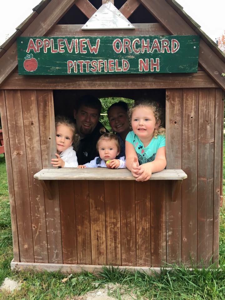 One family sharing a moment at Appleview’s wooden playhouse